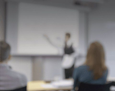 person pointing at a white display board