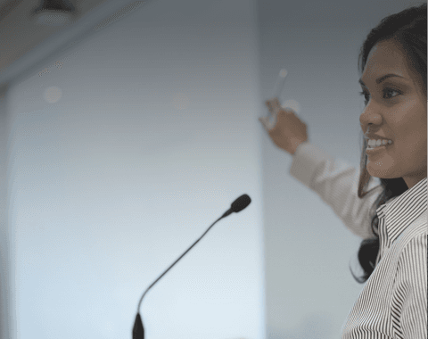 lady pointing at a conference board
