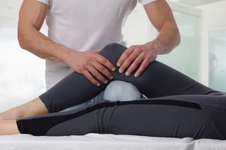 Auto Injury Physical Therapy — Therapist Doing Healing Treatment on Women's Leg in Natick, MA Auto Injury Physical Therapy — Therapist Doing Healing Treatment on Women's Leg in Natick, MA