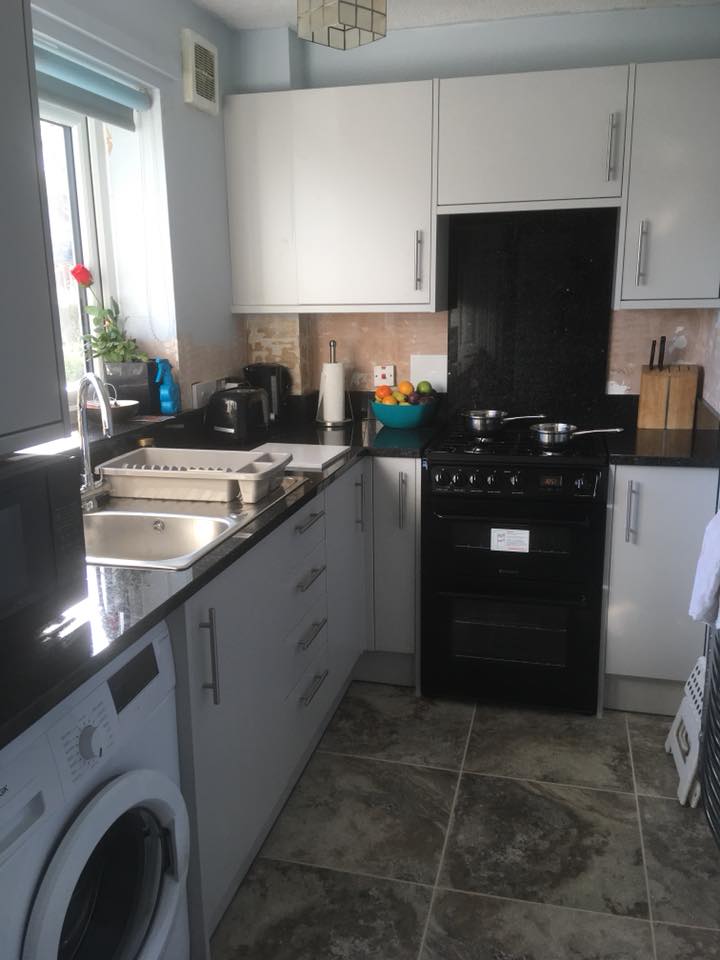 Emerald Black Granite worktops and splashback with Montalcino Volcano Tiles