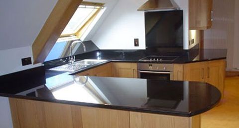 Black granite with breakfast bar, splashback and upstand Black granite with breakfast bar, splashback and upstand