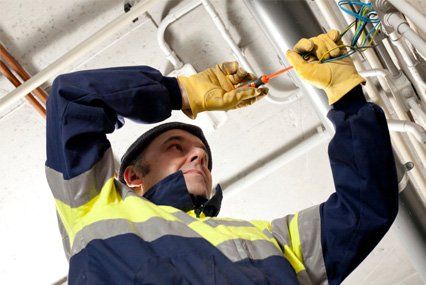 Electrician Repairing Electrical Wirings — Electrical Services in Wilmington, IL