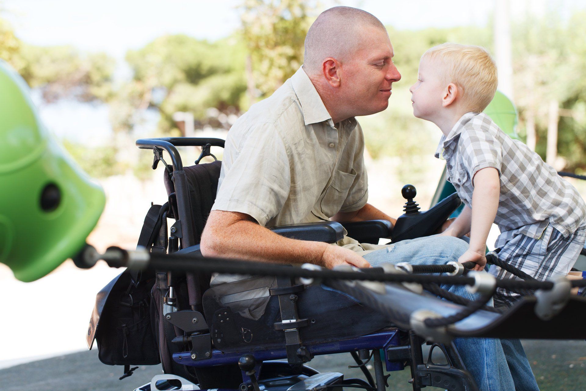 Disabled-Father-play-with-his-little-son-on-the-playground