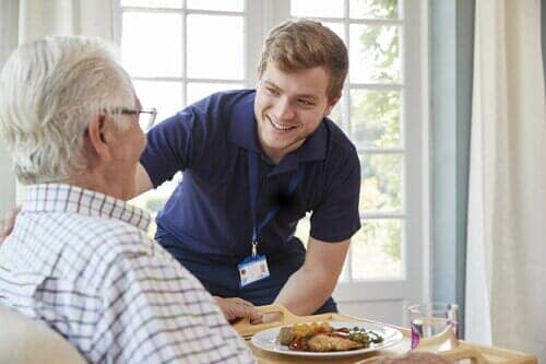 Male Care Worker Serving Dinner - Retirement Home in San Ramon, CA