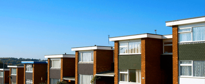Flat roofing products always in stock at the J T Matthews Roofing Centre in Bilston, West Midlands A long row of buildings with flat roofs