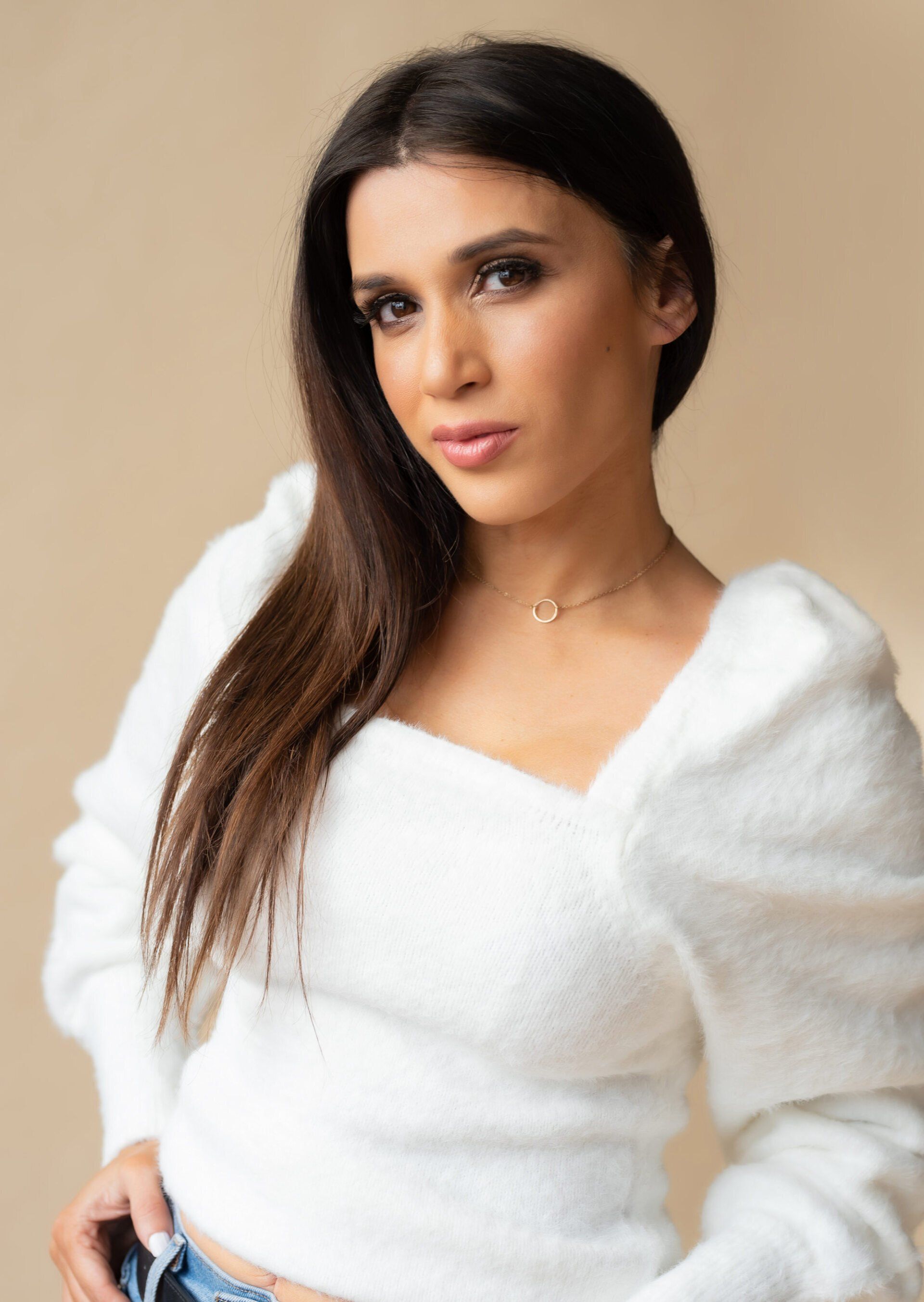 Actress with long hair and soft white sweater in actor headshot