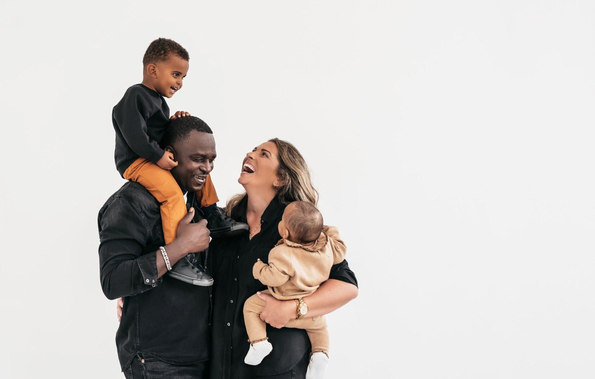 Photo of a parents holding their two children while embraced for toronto gift idea