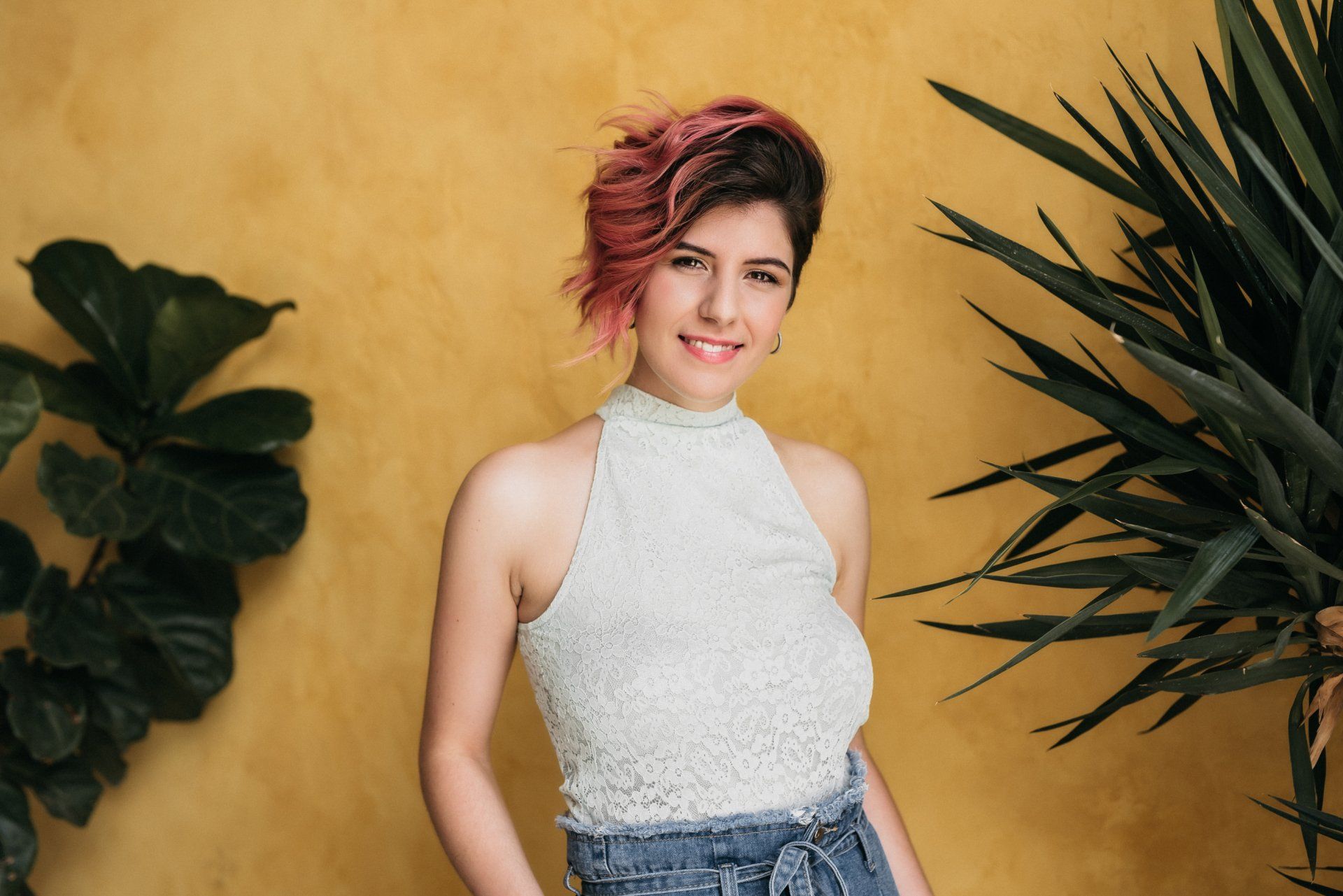 Woman smiling in front of yellow wall for photoshoot gift card idea