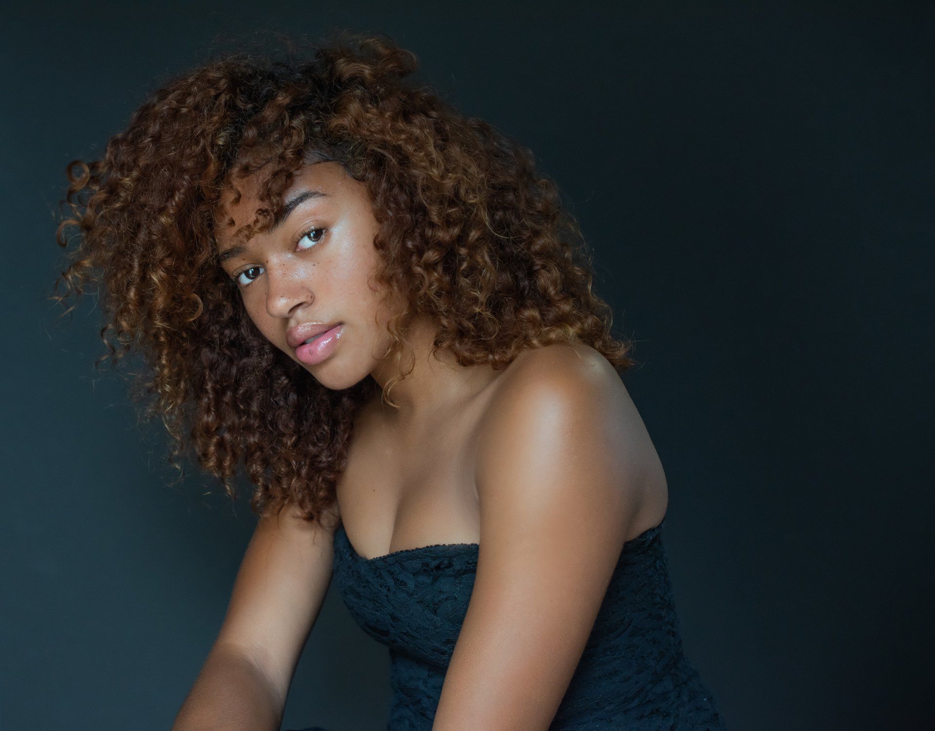 Professional Portrait Photography | Stacey Naglie Toronto | Woman in dark top in front of dark wall
