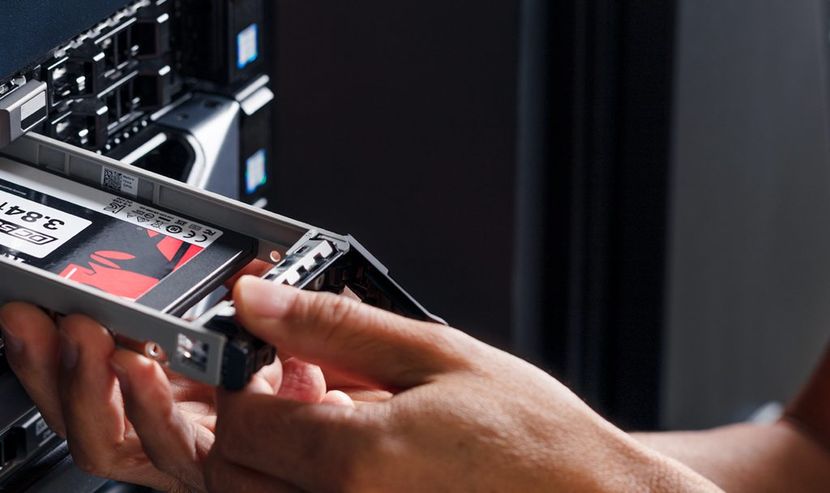 Man inserts SSD into server rack