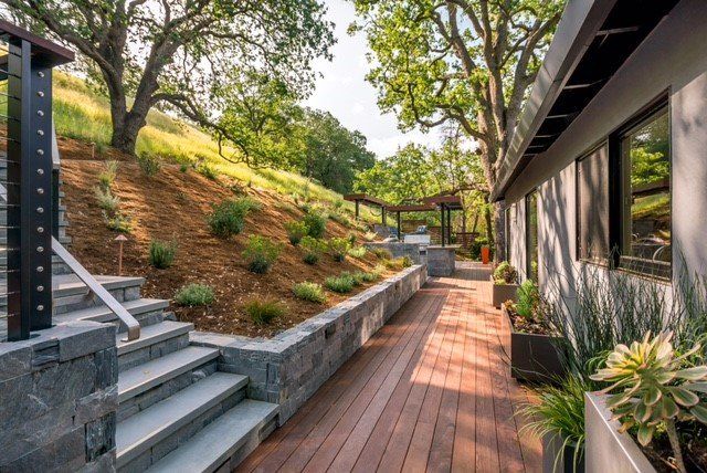 stone retaining wall and steps with wood deck