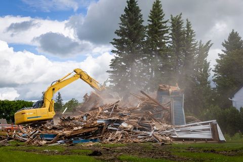 Demolition Vehicle Demolishing A Wood Building — Kansas City, KS — REMCO Demolition, LLC Demolition Vehicle Demolishing A Wood Building — Kansas City, KS — REMCO Demolition, LLC