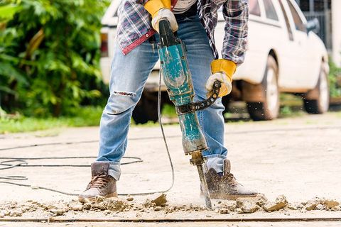 Worker Using Concrete Breaker Electric — Kansas City, KS — REMCO Demolition, LLC Worker Using Concrete Breaker Electric — Kansas City, KS — REMCO Demolition, LLC