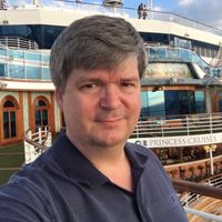 Man posing on a Princess Cruises ship deck with ocean in the background