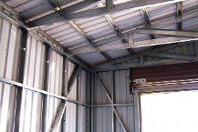 Metal frame dbl garage w/roll-up door