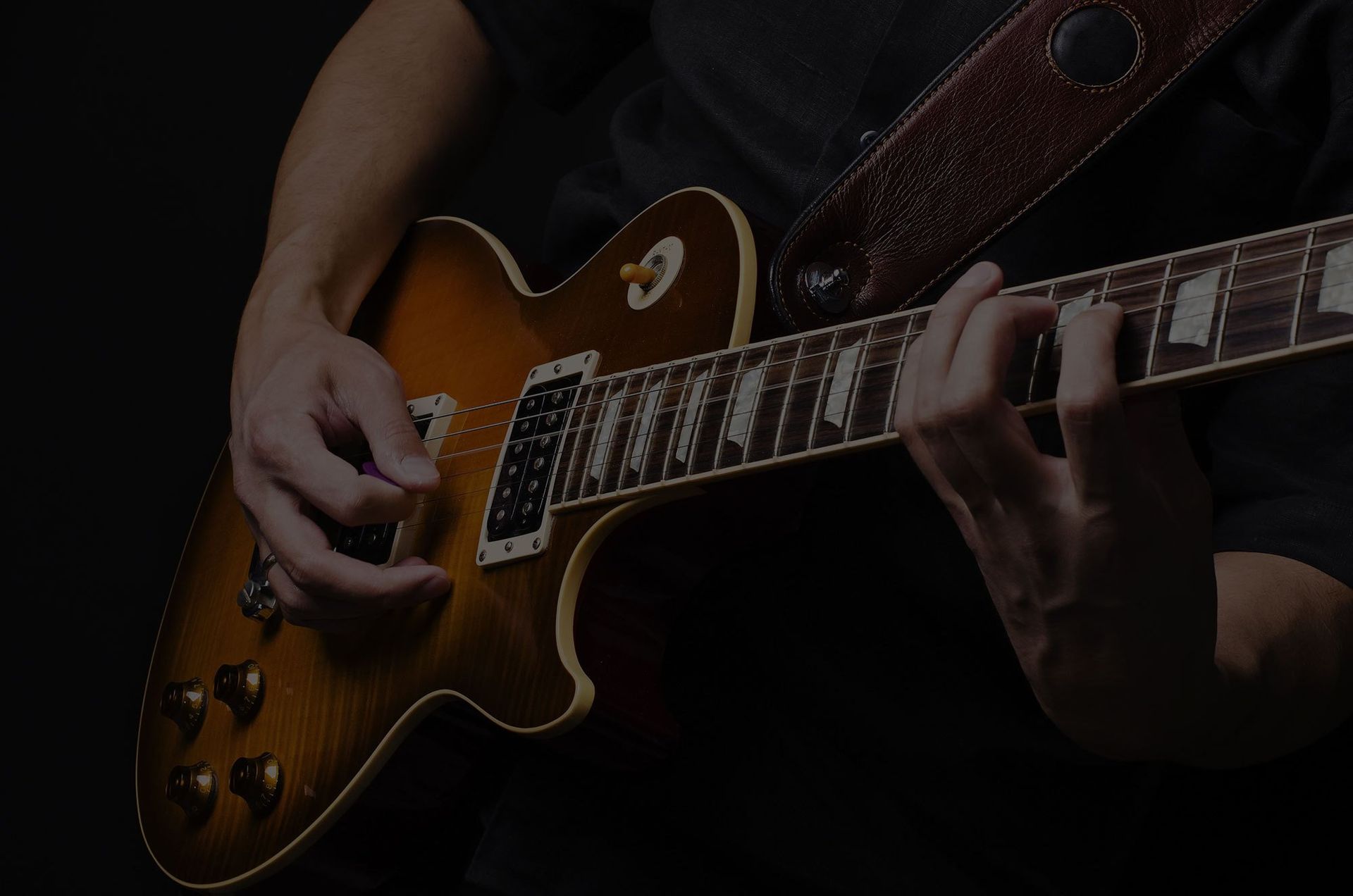 Young Man playing a guitar