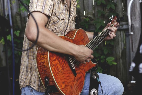 man trying to play the guitar