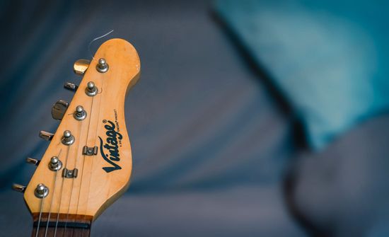 man cutting the strings of the guitar
