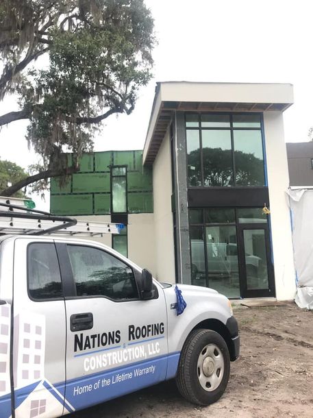 Nations Roofing & Construction truck parked on a roofing jobsite