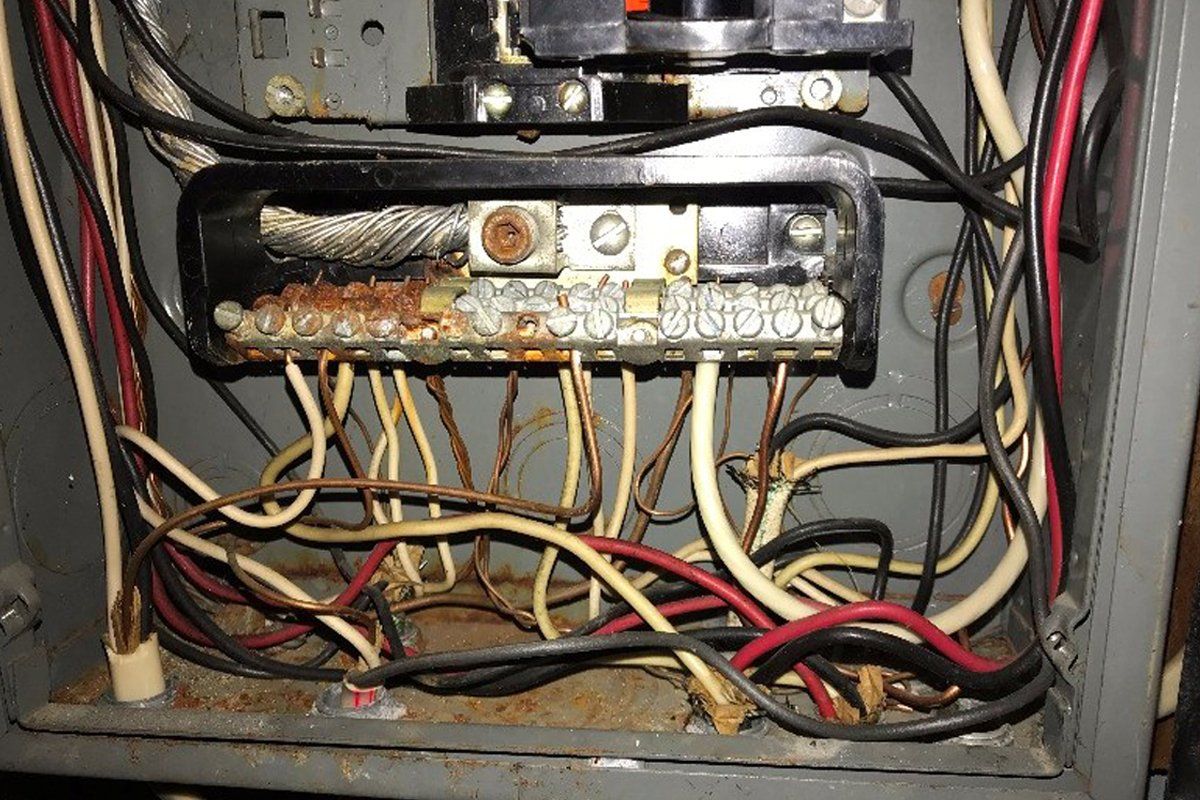 A very messy electrical box with a lot of wires