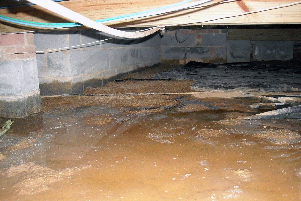 A flooded basement with a lot of water coming out of it.