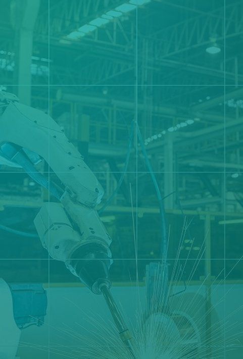 A robotic arm performs industrial welding on a metal component in a factory setting, with sparks flying.