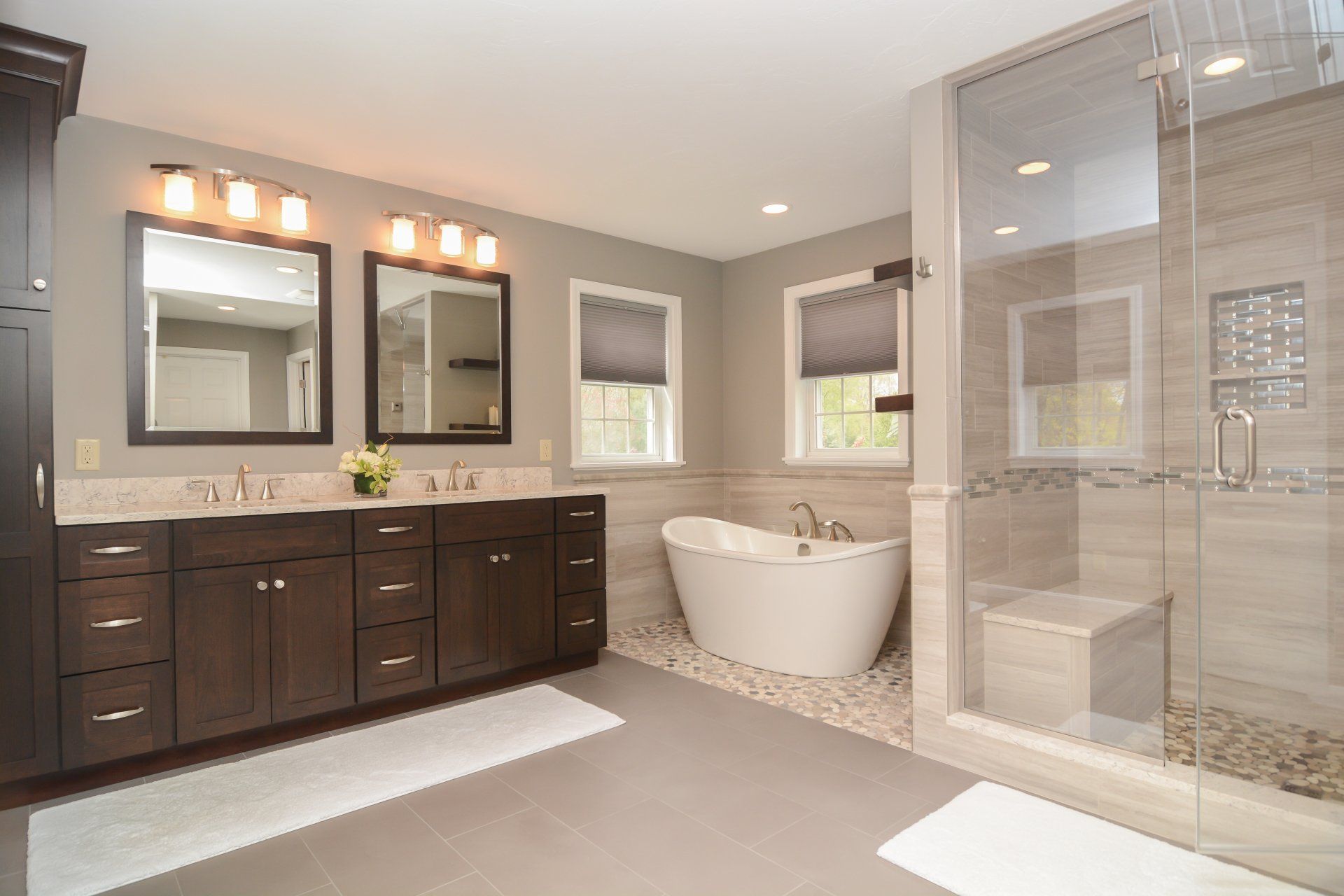 Modern bathroom with double vanity, freestanding tub, and glass walk-in shower
