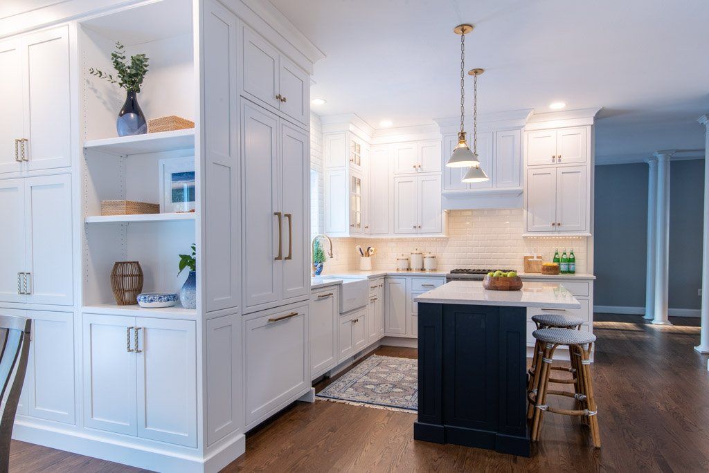 Bright white modern kitchen with island, pendant lights, and built-in cabinetry