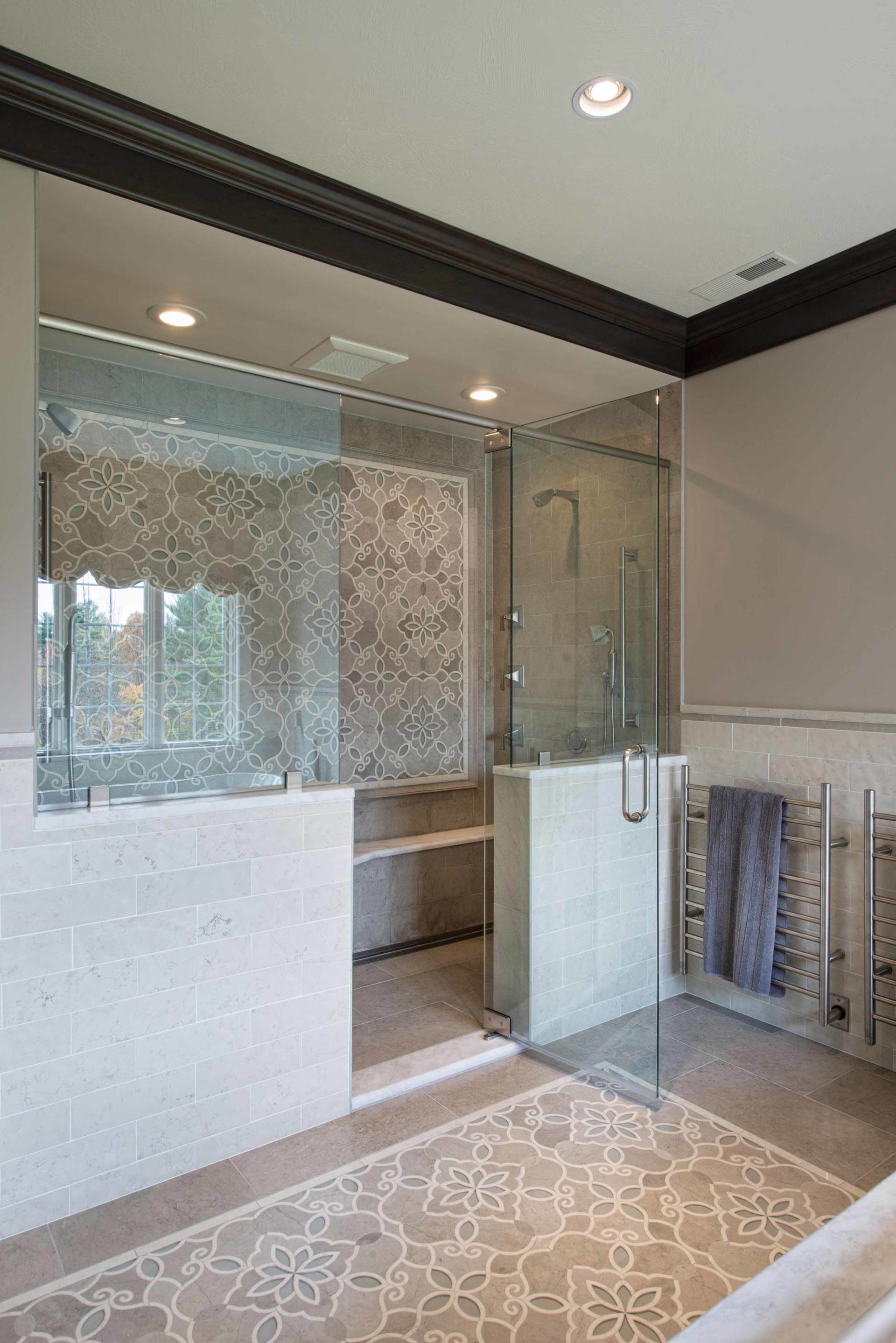 Modern bathroom with walk-in shower, frosted glass partition, and patterned tile floor