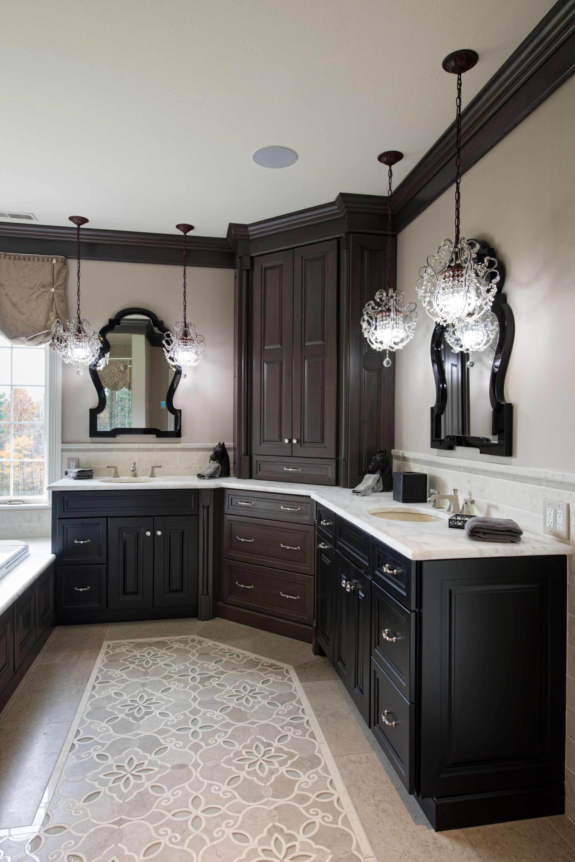 Elegant dark-wood bathroom with white countertops, black accents, and mirrored vanities.
