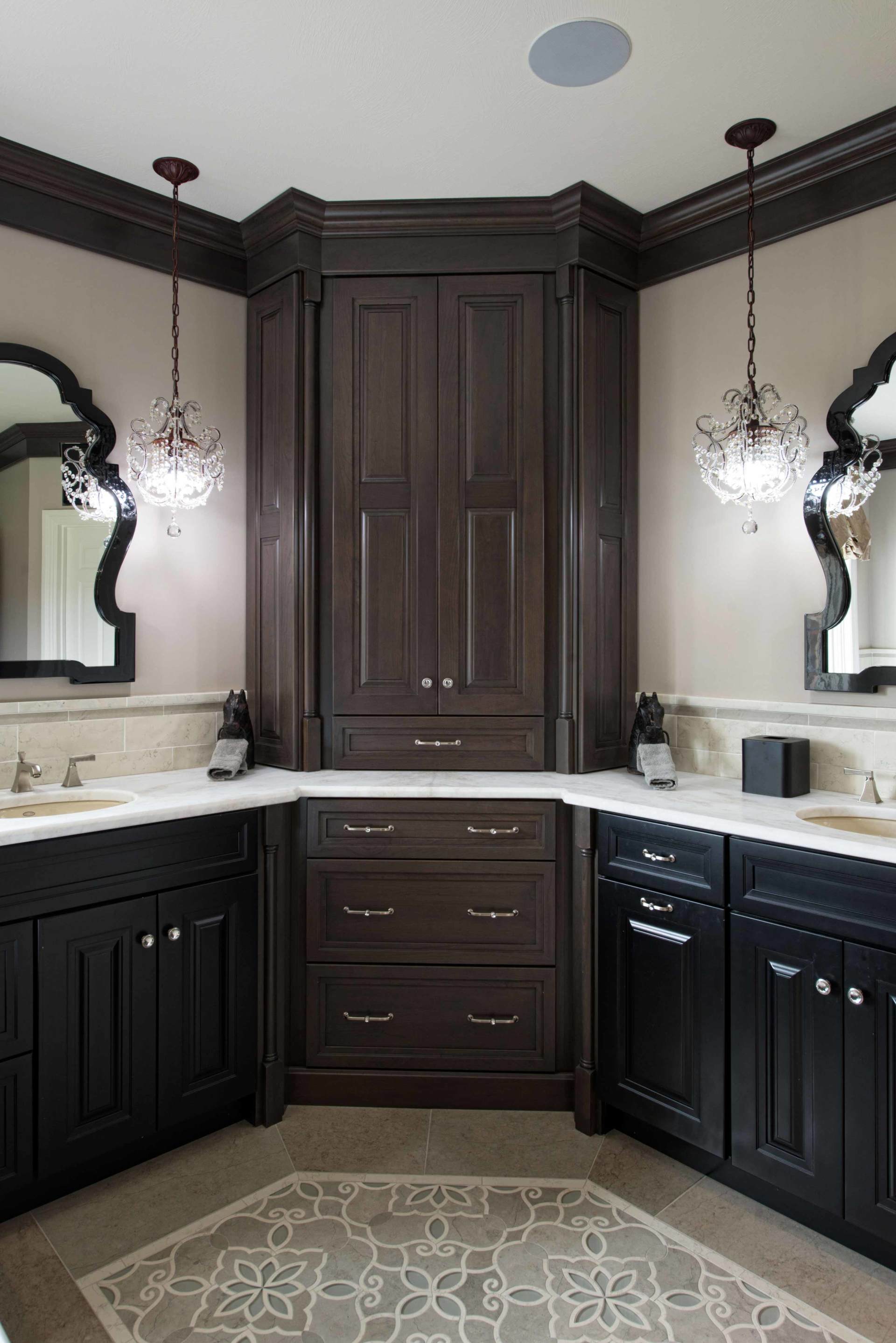 Elegant dark wood bathroom vanity with double sinks, mirrors, and ornate wall sconces