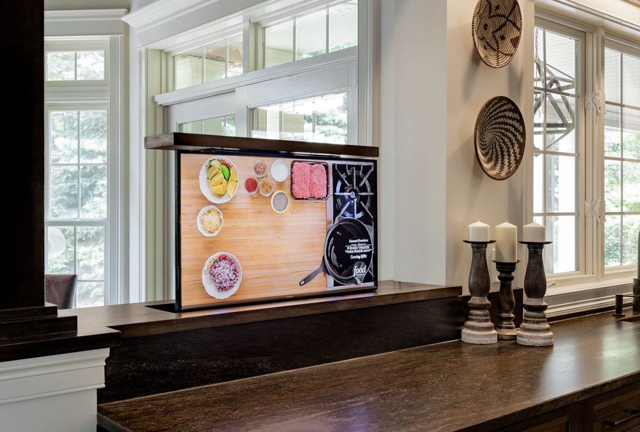 Kitchen counter with a cork board, candles, and decorative wall art in a bright room
