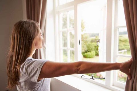 Woman looking through the window — Drapes in Bensalem, PA Woman looking through the window — Drapes in Bensalem, PA