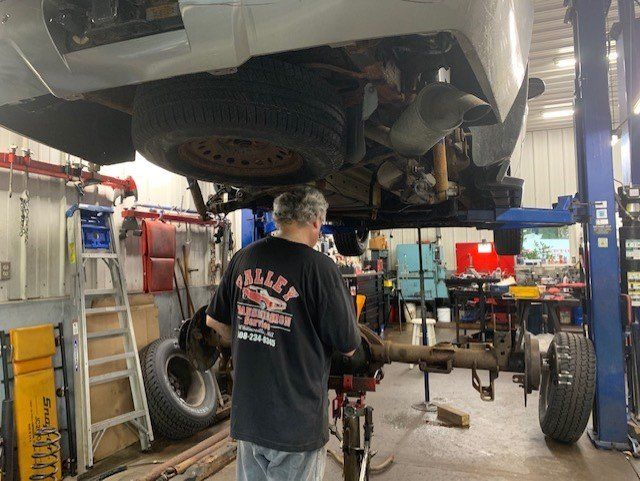 Transmission Service — Mechanic Working on Car Transmission in Northbridge, Massachusetts