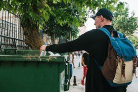 Man Throwing On Dumpster — South Plainfield, NJ — Total Trash Removal