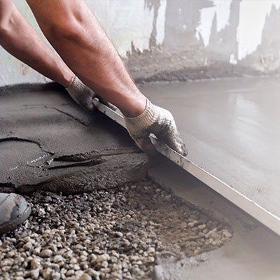 Hardscape Contractor — Worker Levels the Floor with Cement Mortar in Cedar Glen, CA Hardscape Contractor — Worker Levels the Floor with Cement Mortar in Cedar Glen, CA