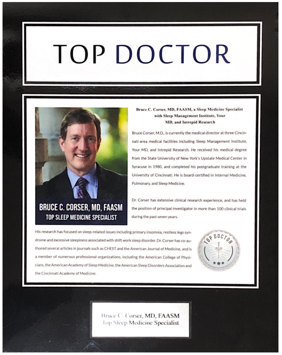 A picture of a man in a suit and tie is on a top doctor certificate.