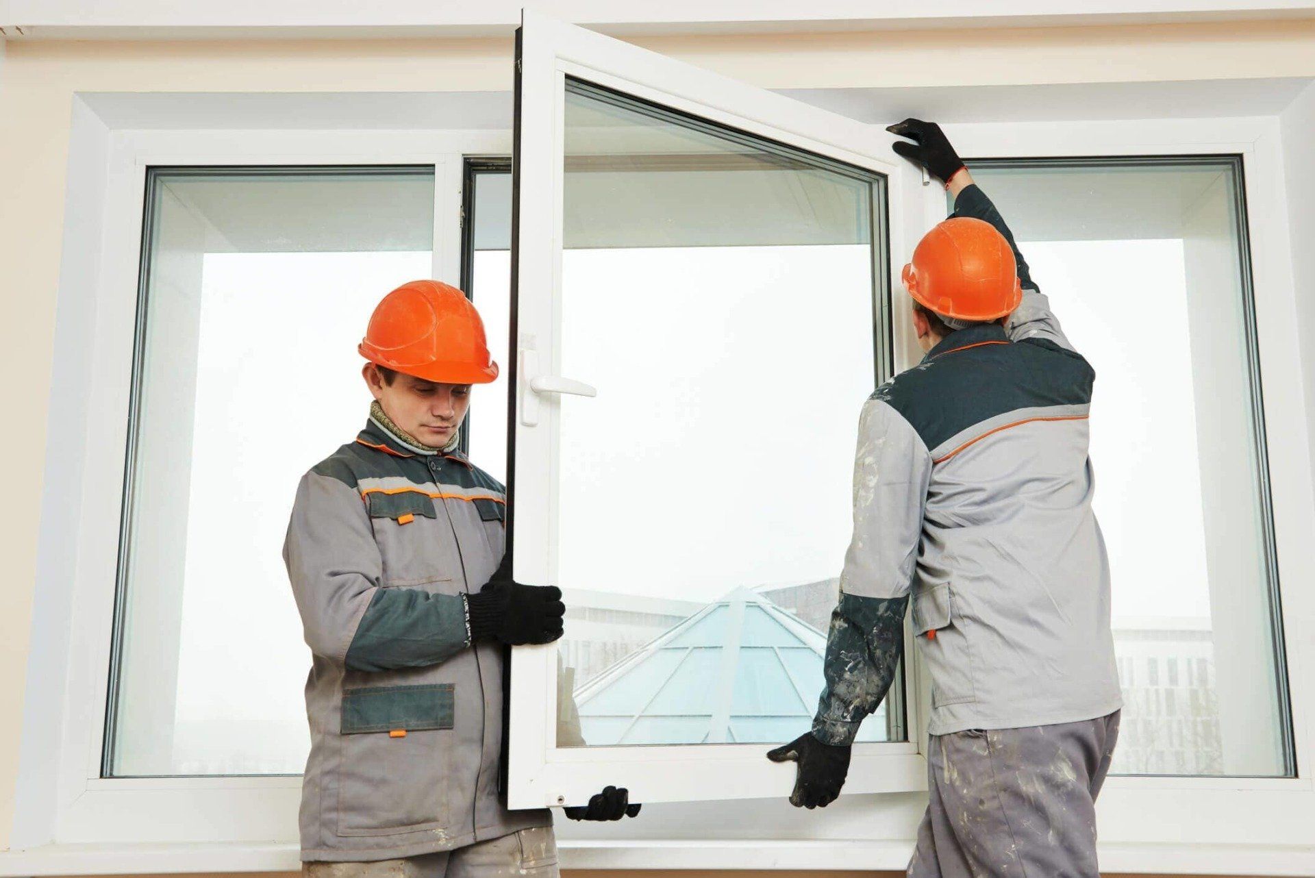 Two workers installing window - Window Manufactures and Wholesalers in Passaic, NJ Two workers installing window - Window Manufactures and Wholesalers in Passaic, NJ