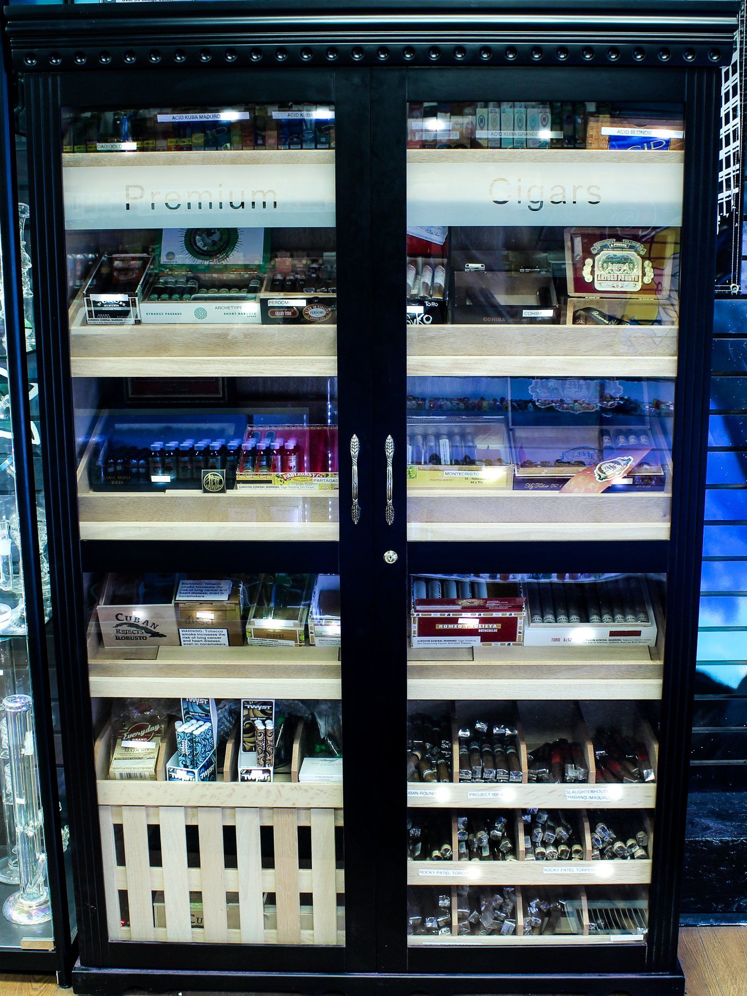 A cabinet with a glass door filled with lots of items