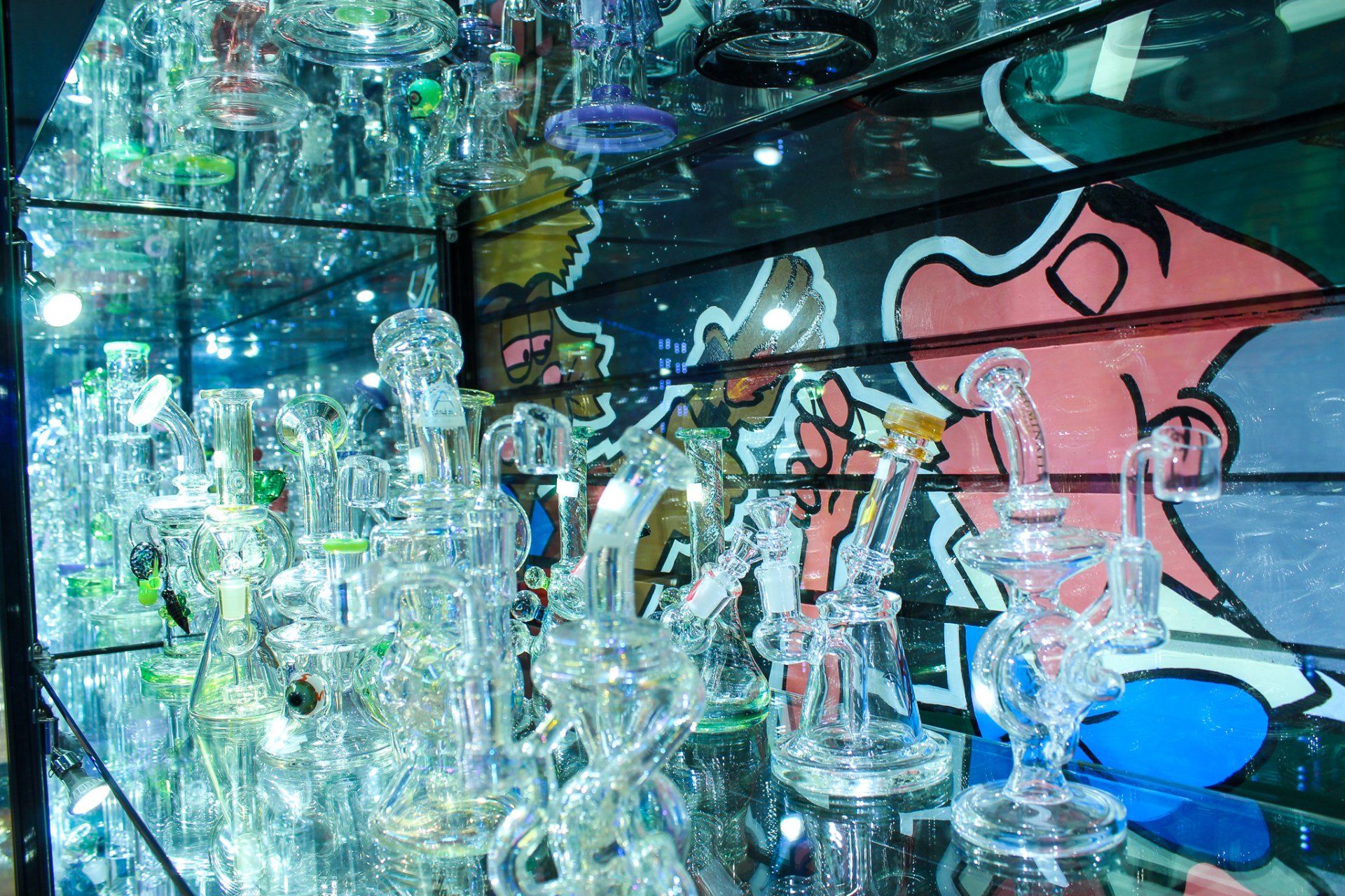 A display case filled with lots of glass pipes in a store.