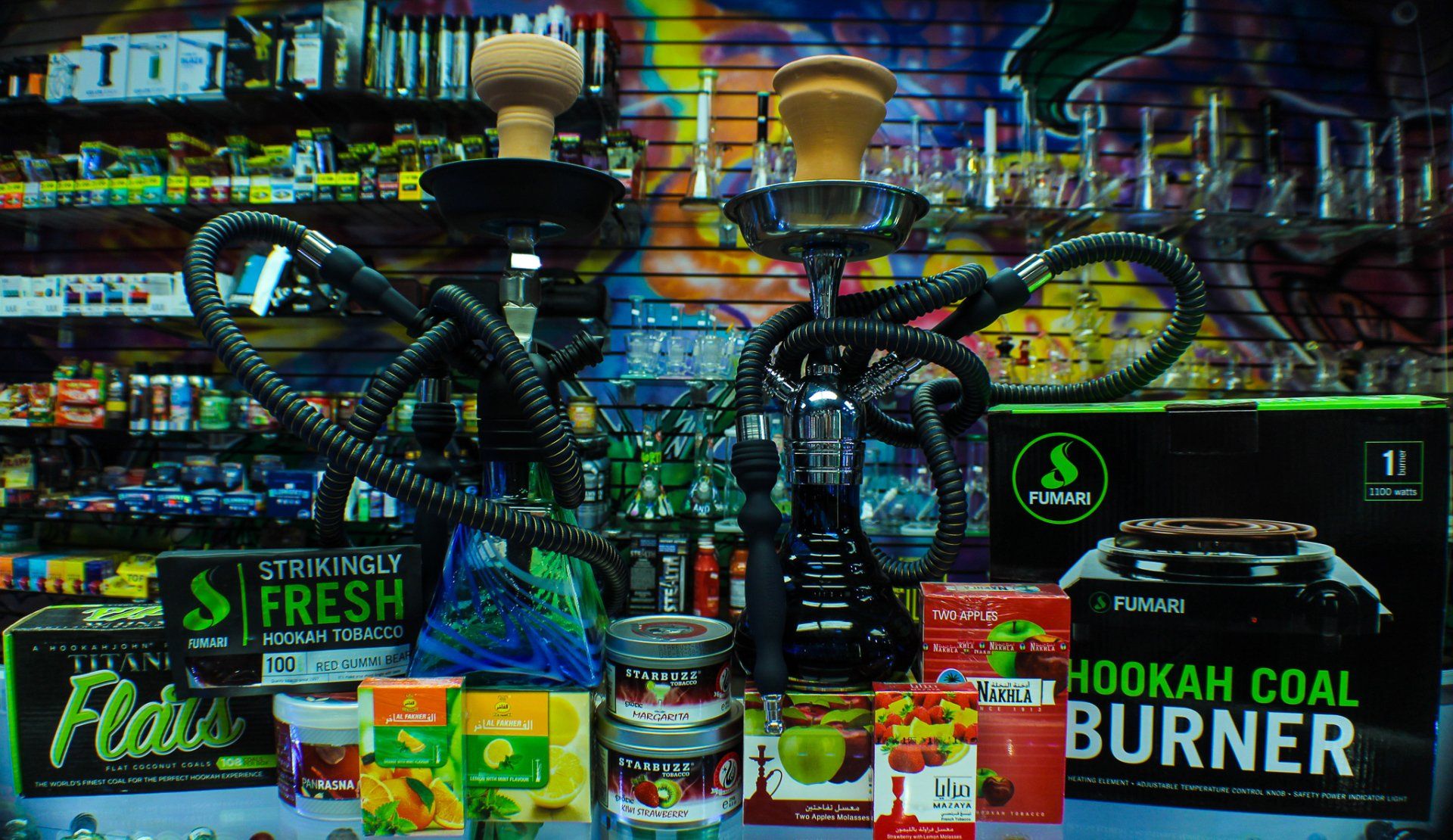 Hookahs are displayed in front of a sign that says hookah coal burner