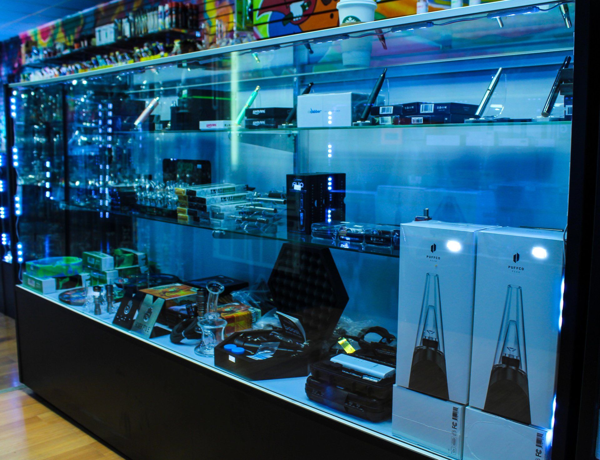 A glass display case filled with a variety of items