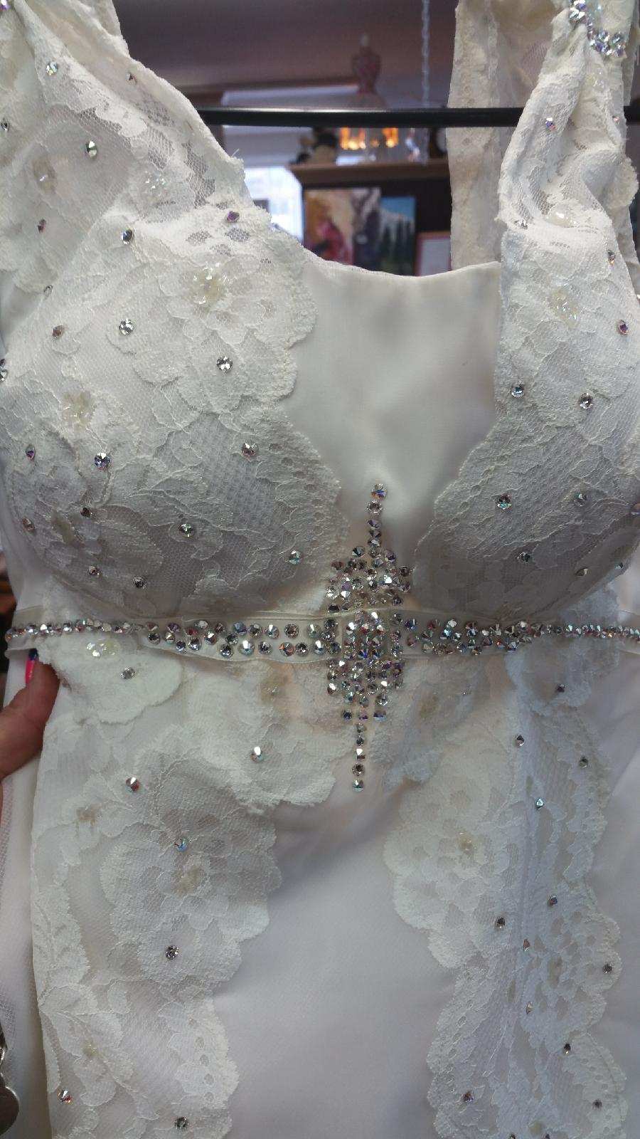 White beaded wedding dress bodice with a jeweled cross waist detail