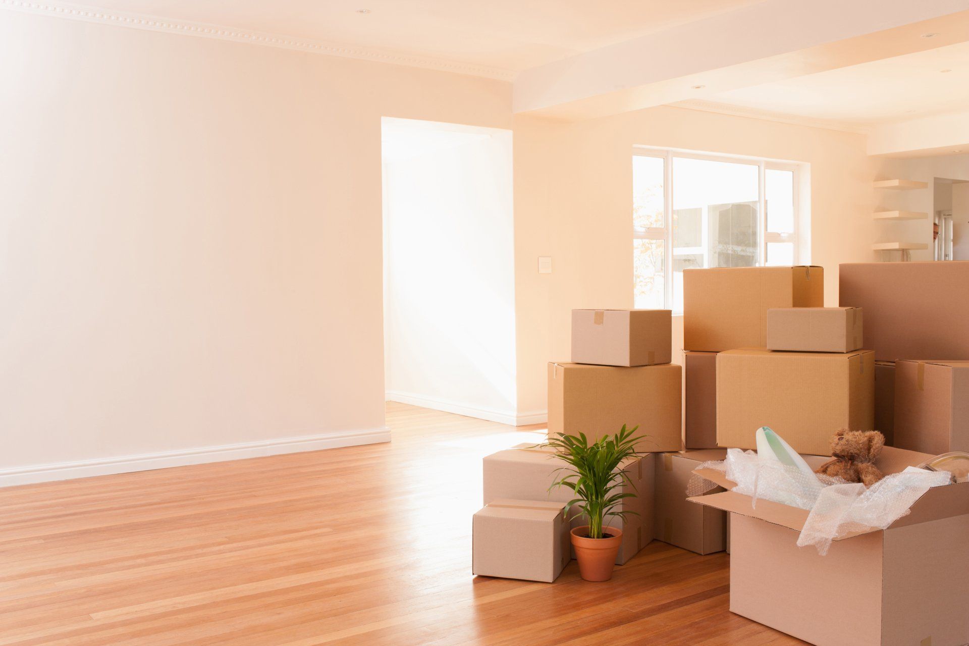 Boxes stacked on wooden floor of new house in Columbia, TN