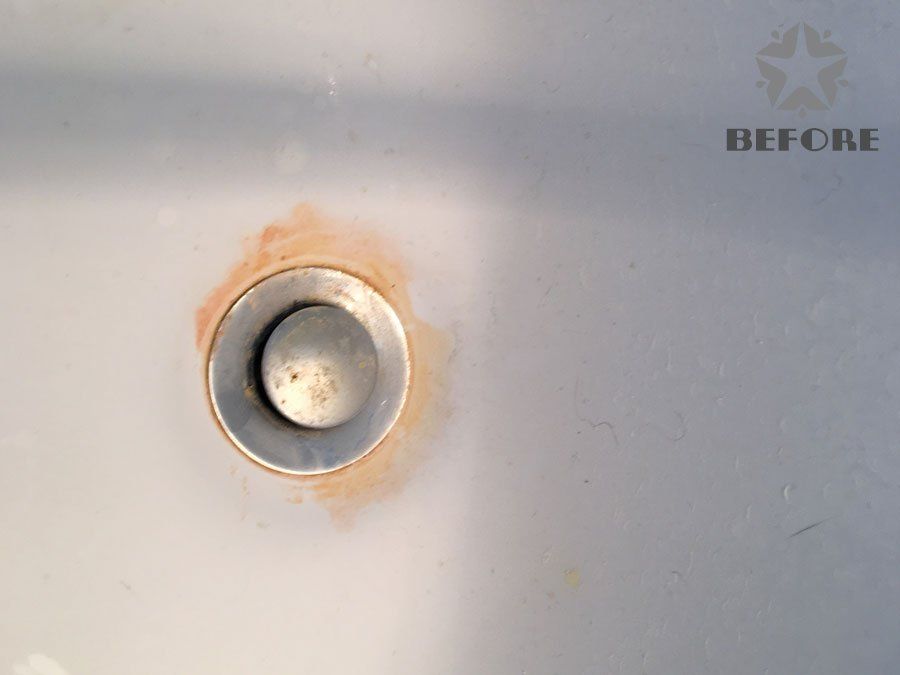 Rust-stained metal drain or plug labeled “BEFORE” on a light gray surface.