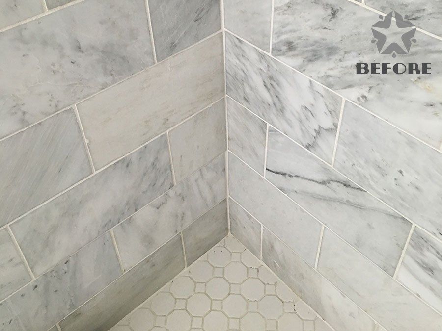 Tiled shower corner with gray marble-look walls and hexagon floor tile, labeled “BEFORE”