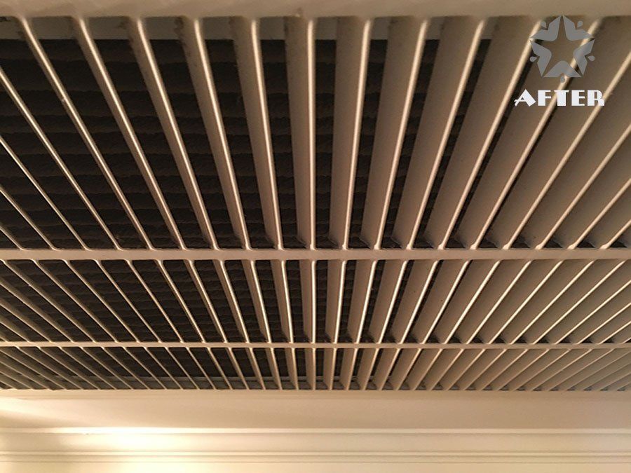 Close-up of beige ceiling vent slats and a light fixture with a small “AFTER” label in the corner