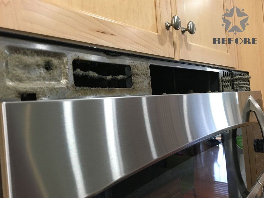 Damaged kitchen cabinet behind a stainless steel dishwasher, with broken trim and open gaps