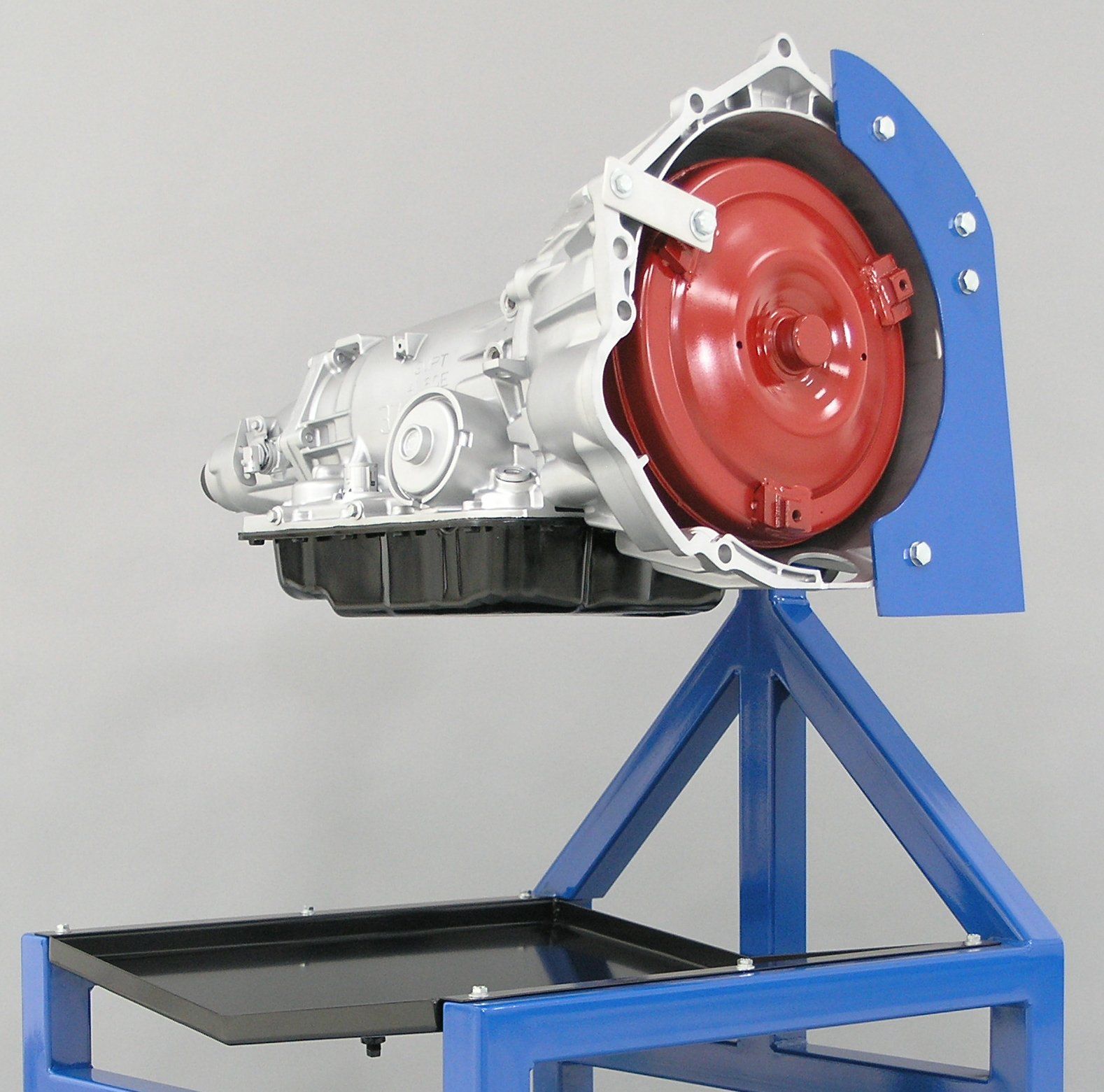 A red and silver gearbox is on a blue stand