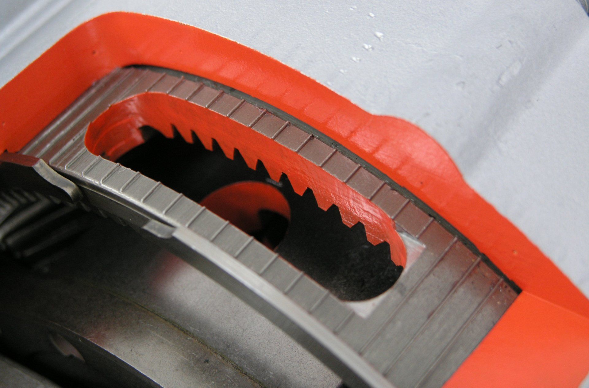 A close up of a circular saw blade with orange trim